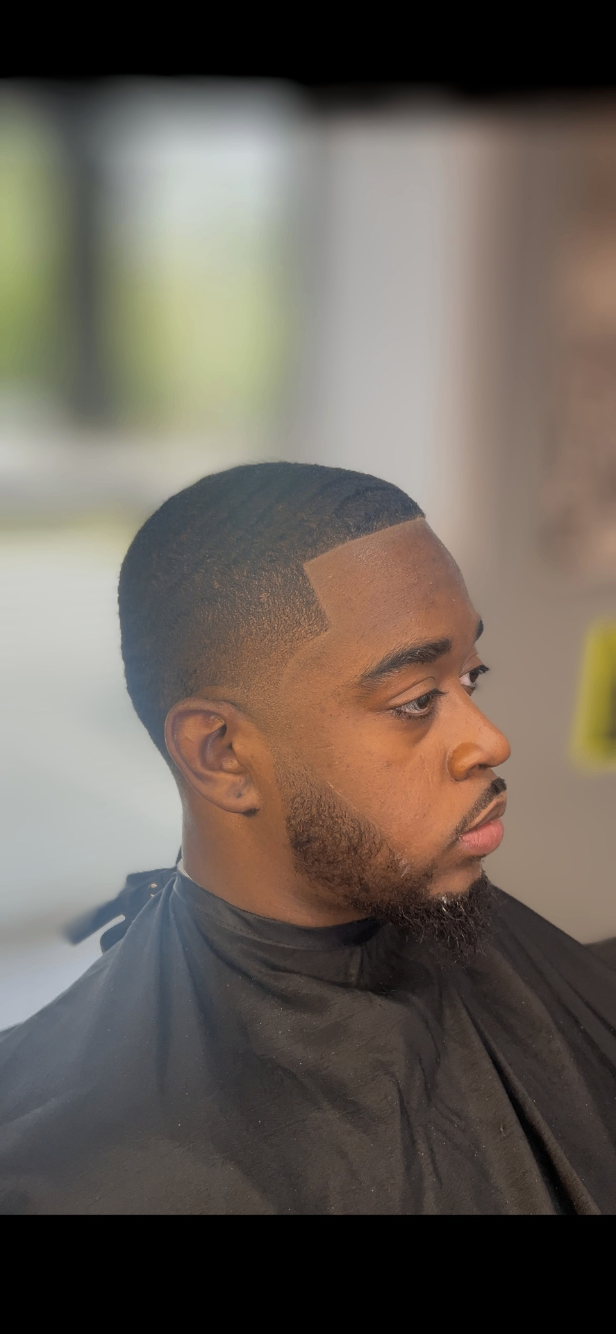 Fresh fade with crisp line-up and beard grooming