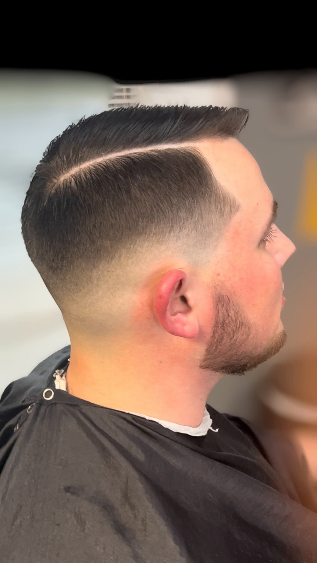 Classic comb-over fade with sharp hard part
